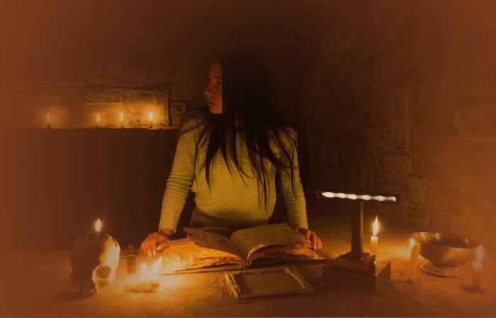Девушка проводит ритуал со свечами